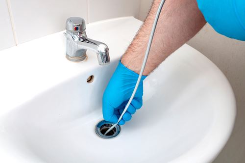 Use a plunger to dislodge wad of hair plugging bathtub drain