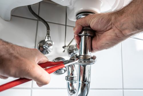 plumber taking apart drain